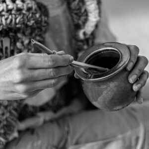 Hands holding mate cup in Uruguay showcasing traditional drink.